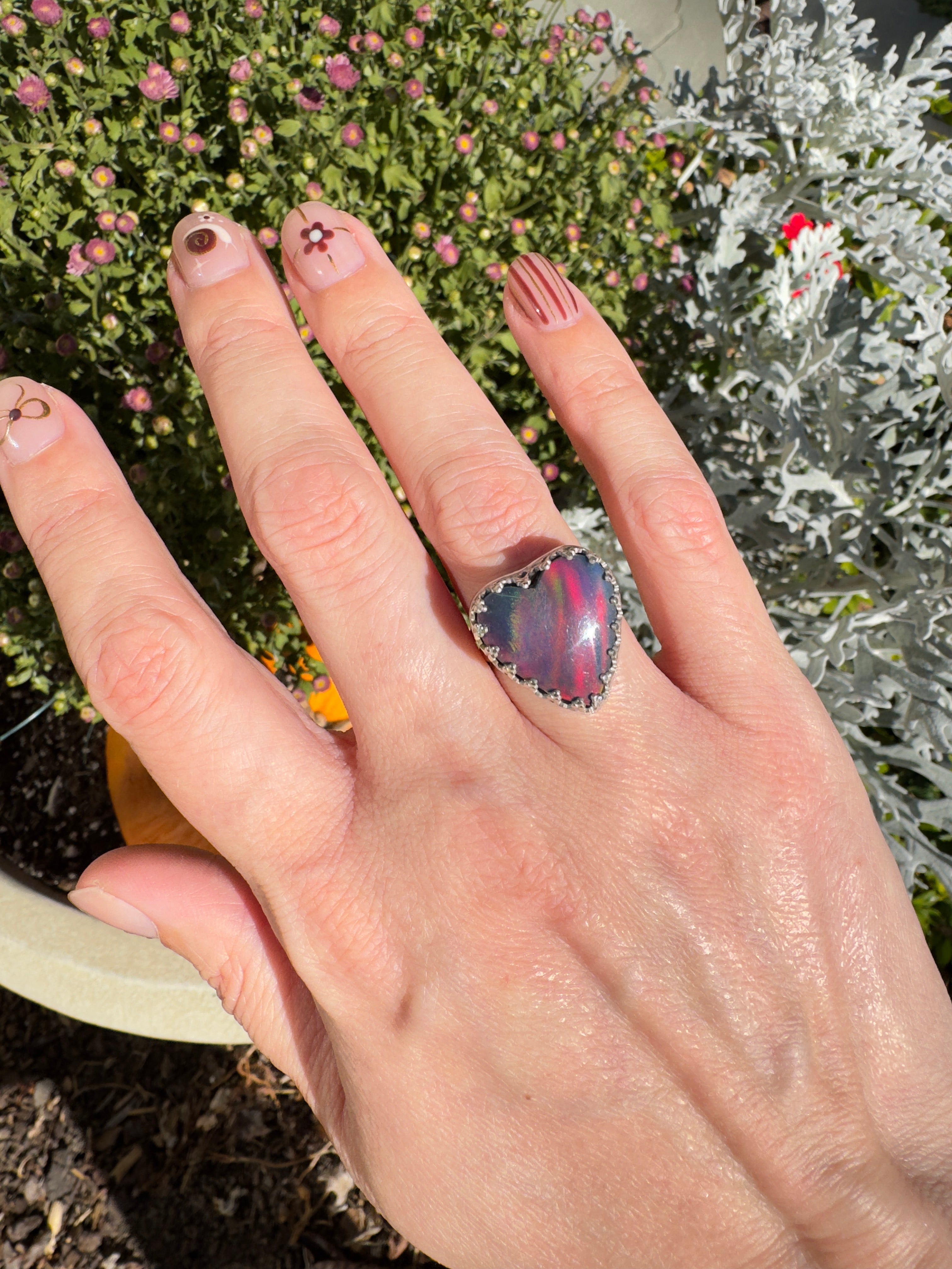 Beautiful heart shaped Aurora Opal on a wide sterling silver double band. So many pretty colors in this. One of a kind. The perfect heart ring for Valentine's Day. Size 6. Purple, blue, pink, and even green in this ring.