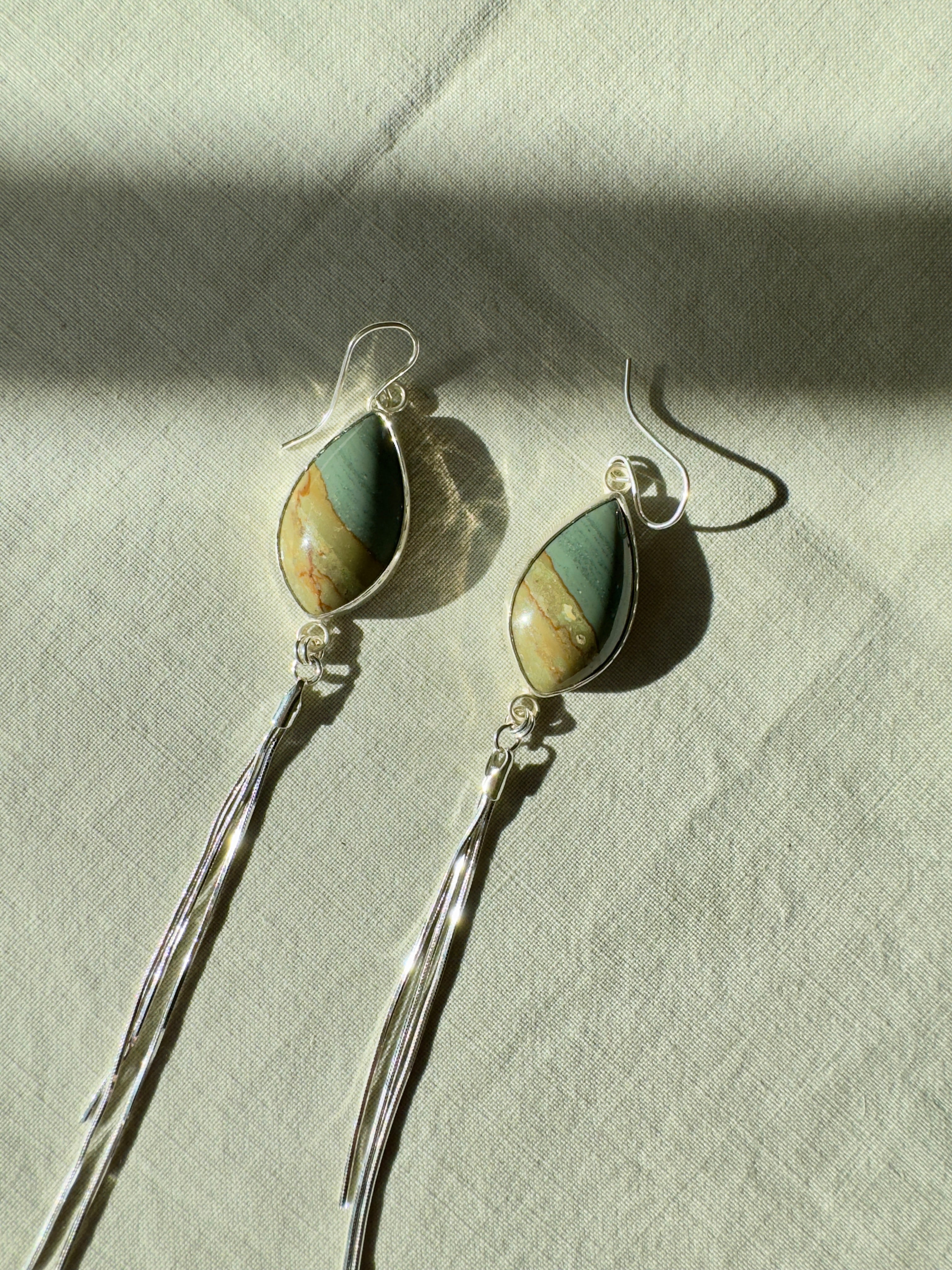 Blue Green Succor Creek Jasper on sterling silver with sterling silver snake chain dangles. The fringe-like chain adds fun movement to these one of a kind earrings.