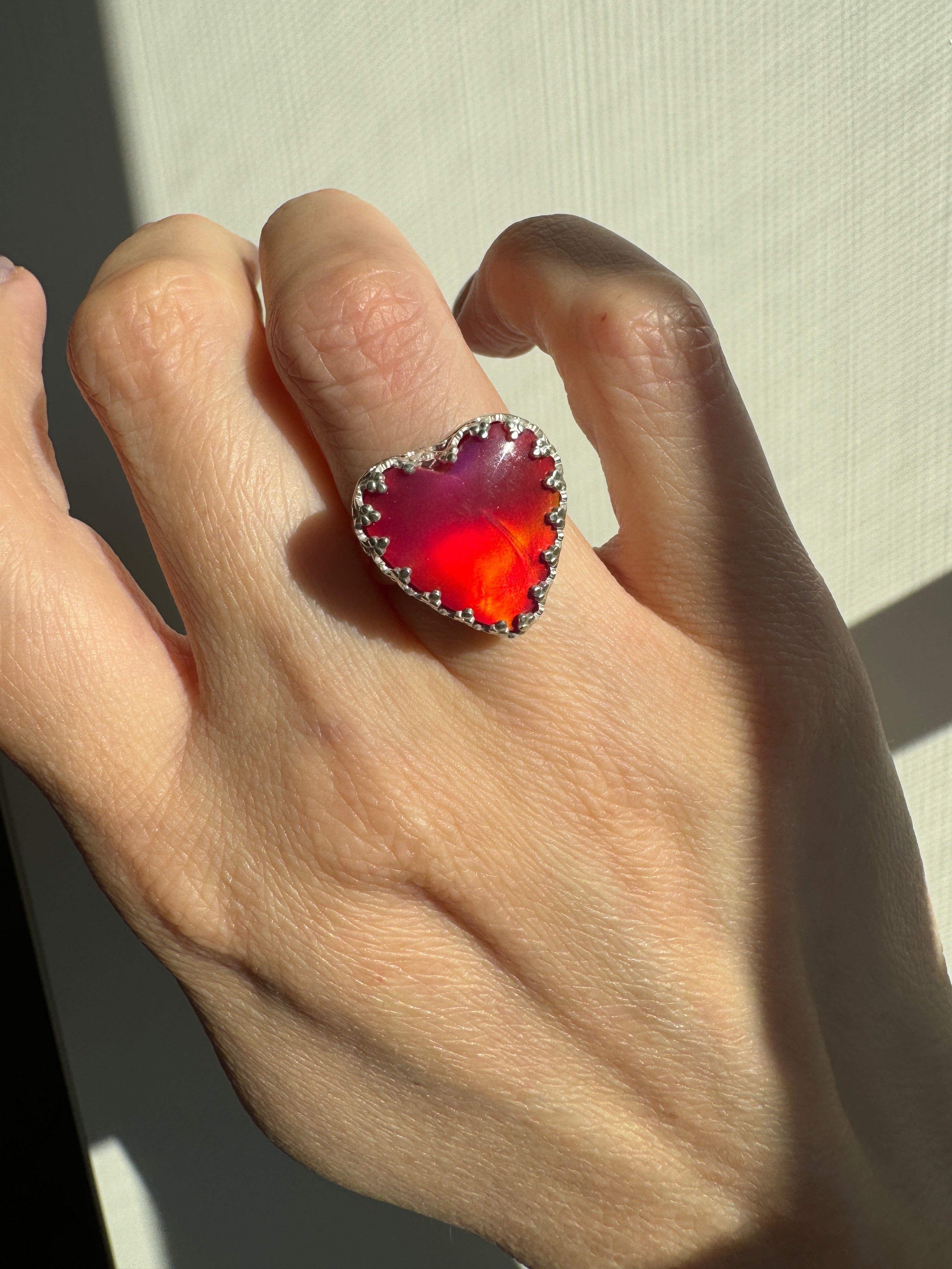 Beautiful heart shaped Aurora Opal on a wide sterling silver double band. Gorgeous bright pinks and reds in this stone. One of a kind. The perfect heart ring for Valentine's Day. Size 6.25