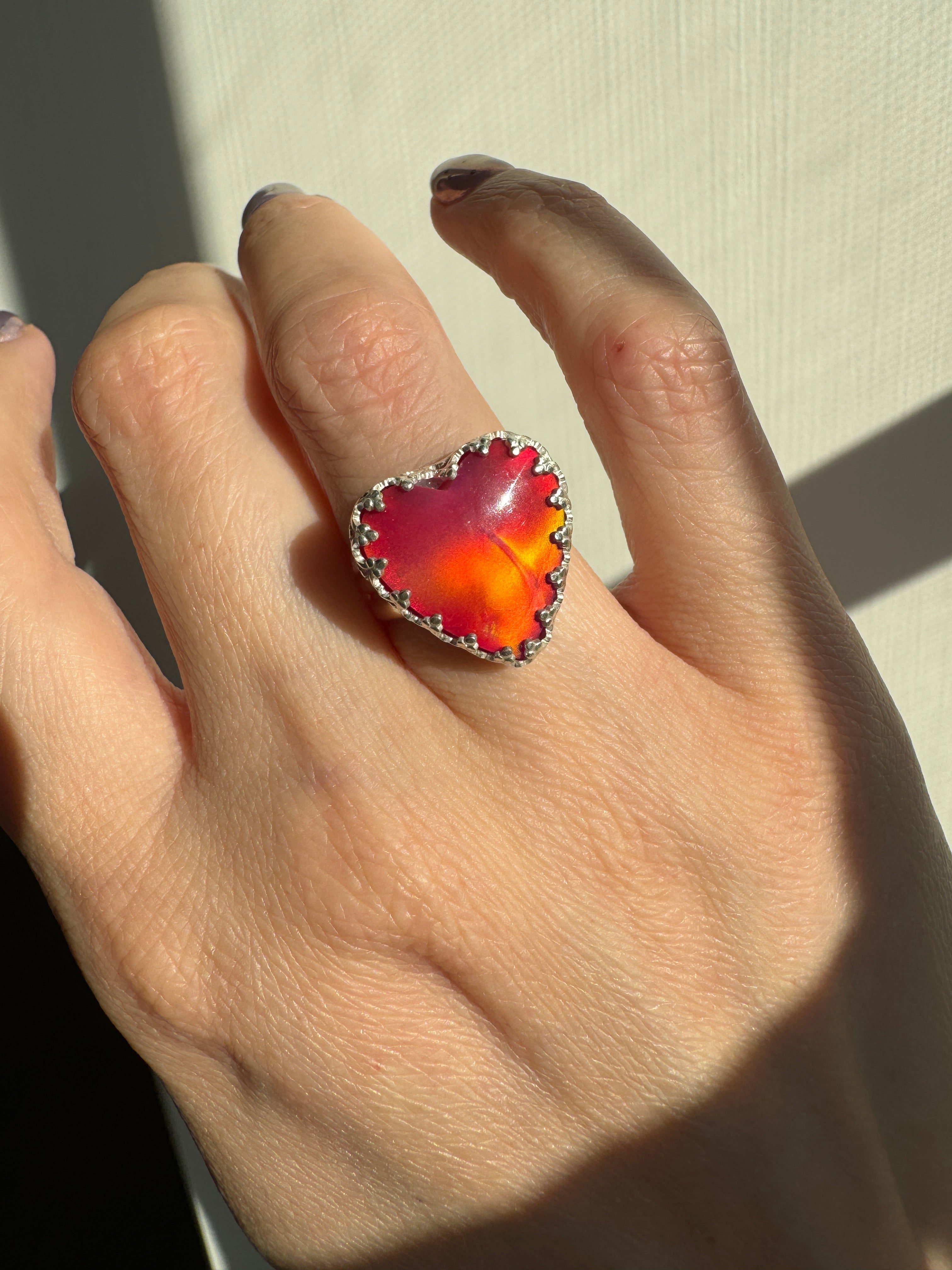 Beautiful heart shaped Aurora Opal on a wide sterling silver double band. Gorgeous bright pinks and reds in this stone. One of a kind. The perfect heart ring for Valentine's Day. Size 6.25