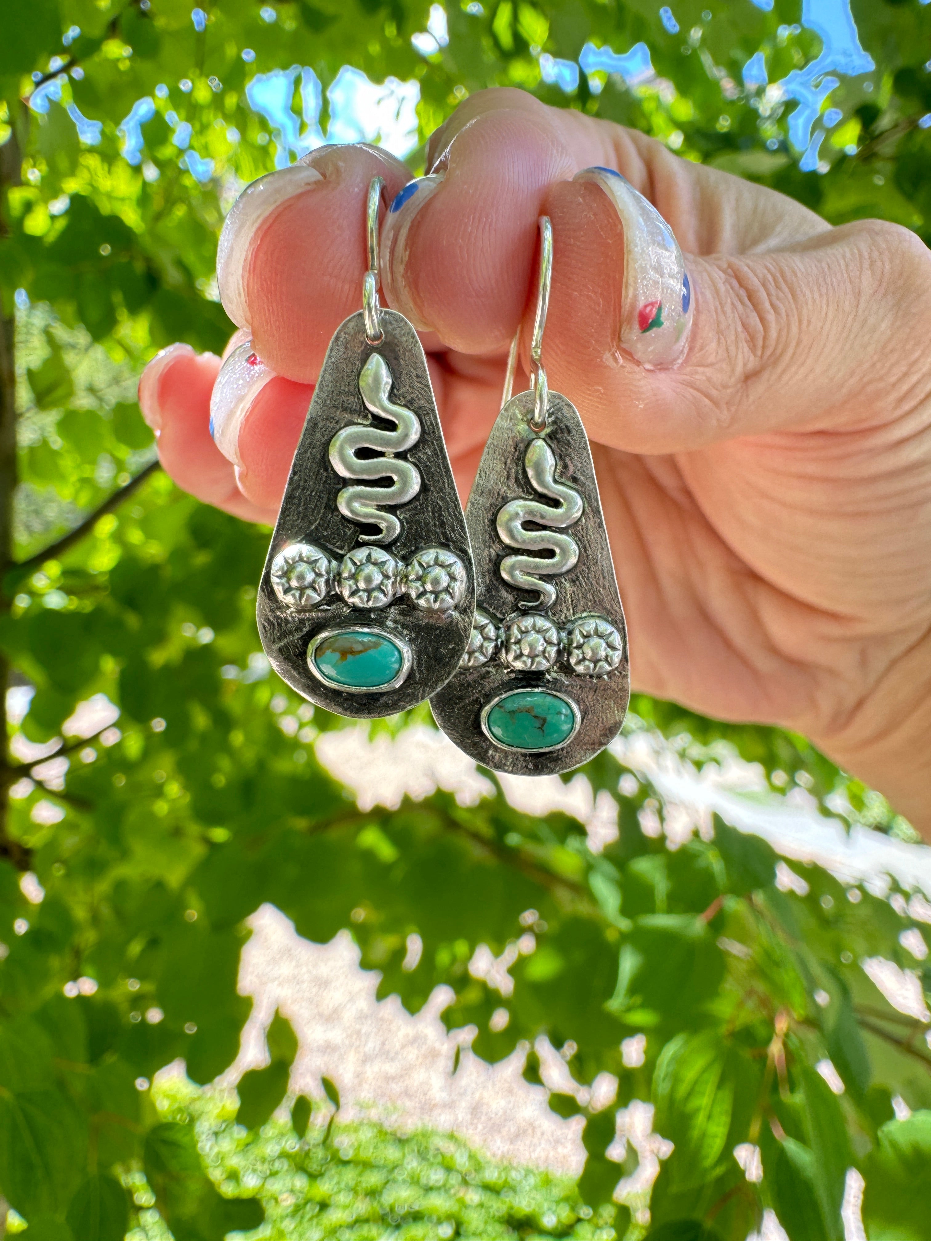 Sterling silver earrings with sterling silver snakes and carico lake turquoise. The ear wire is sterling silver. This is a one of a kind pair.