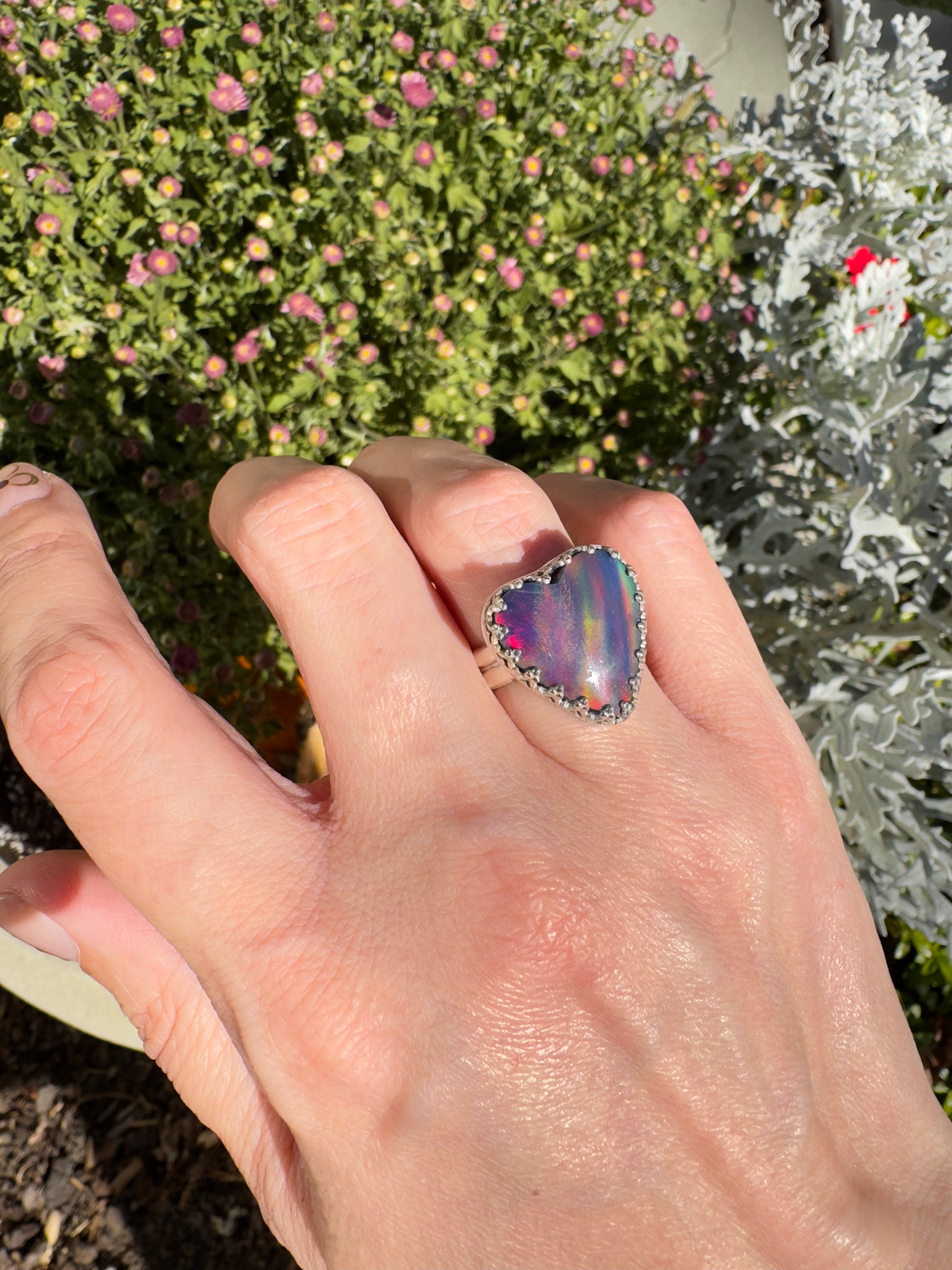 Beautiful heart shaped Aurora Opal on a wide sterling silver double band. So many pretty colors in this. One of a kind. The perfect heart ring for Valentine's Day. Size 6. Purple, blue, pink, and even green in this ring.