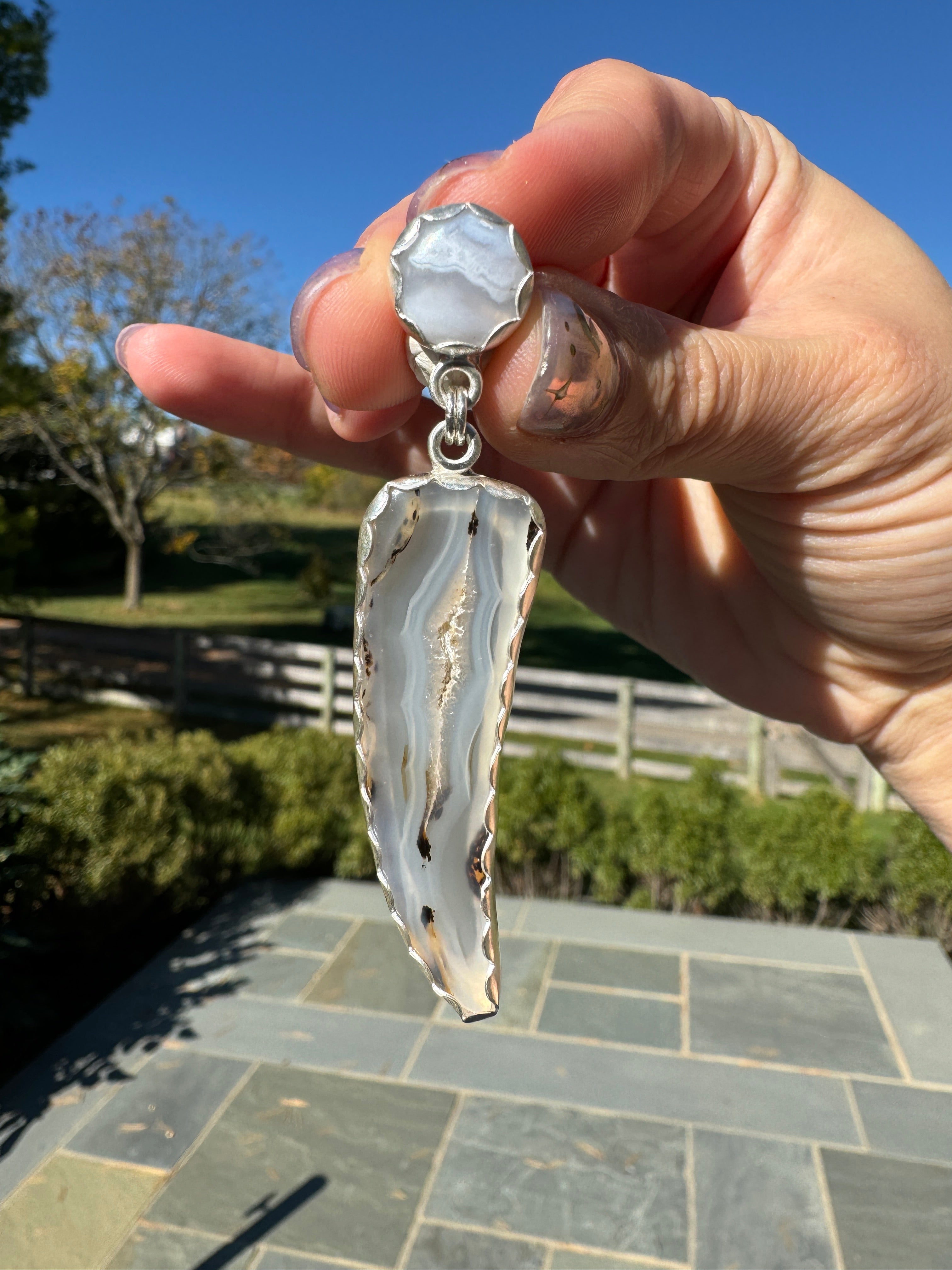 Gorgeous Montana Yellowstone Agate wrapped in fine silver and dangling from periwinkle chalcedony studs. This Montana agate was dug and cut by a Montana born female miner, making this pair extra special. These look stunning on, especially when the light hits the agate because I cut out most of the silver in the back to allow light to shine through and also keep these very lightweight and easy to wear. One of a kind pair.