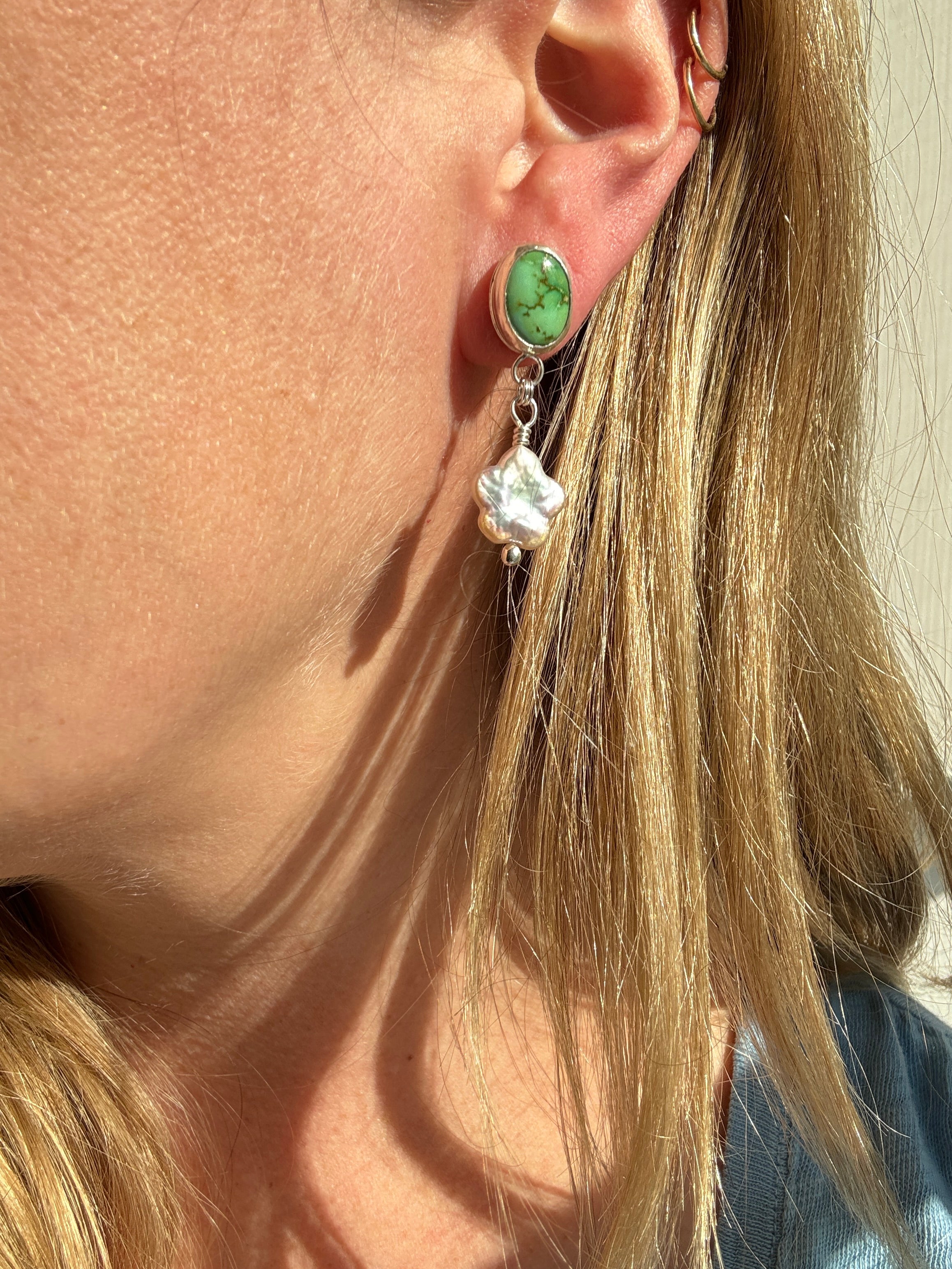 Verde Valley Turquoise set in a fine silver bezel with flower shaped pearls dangling below. The posts and ear backs are sterling silver.