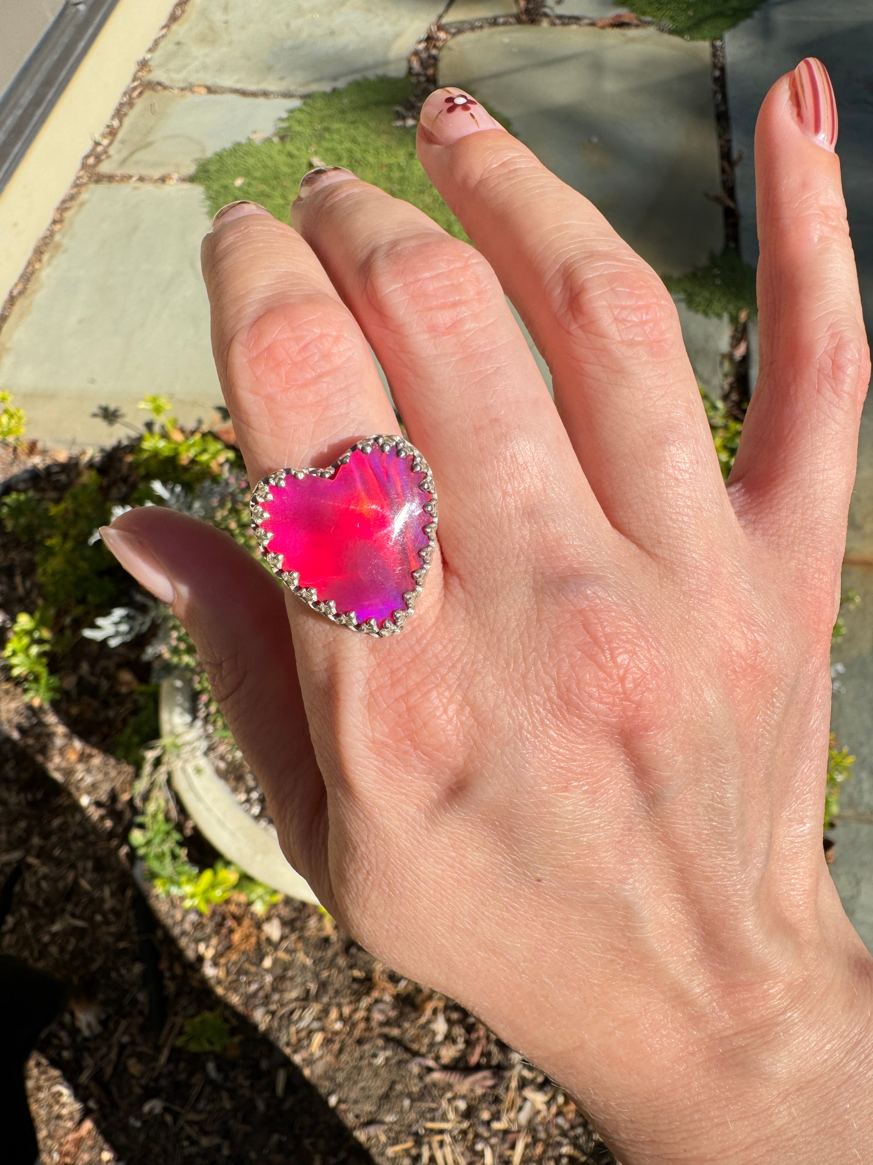 Beautiful heart shaped Aurora Opal on a wide sterling silver double band. Pretty tones of pink and red.  One of a kind. The perfect heart ring for Valentine's Day. Size 8