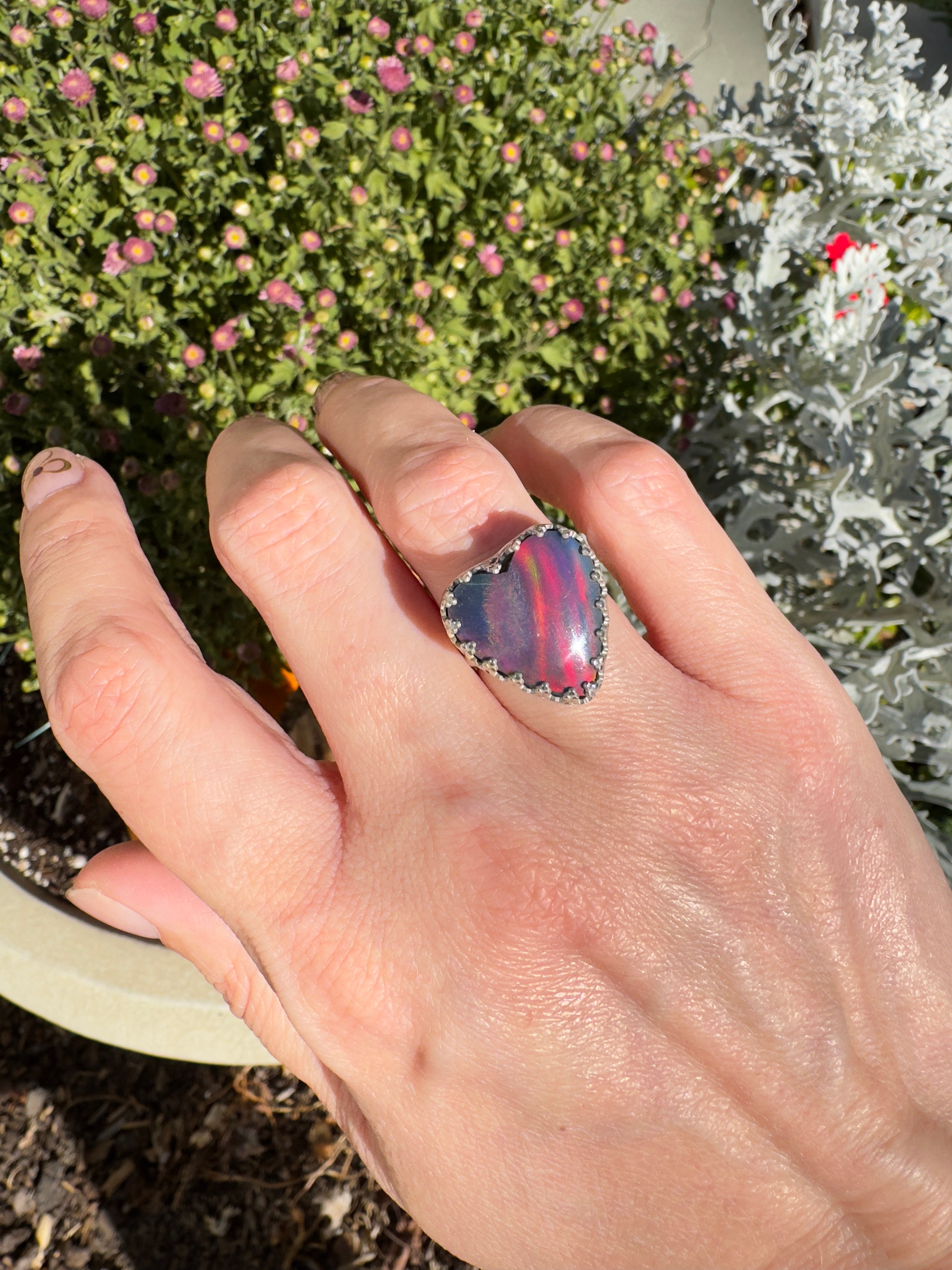 Beautiful heart shaped Aurora Opal on a wide sterling silver double band. So many pretty colors in this. One of a kind. The perfect heart ring for Valentine's Day. Size 6. Purple, blue, pink, and even green in this ring.