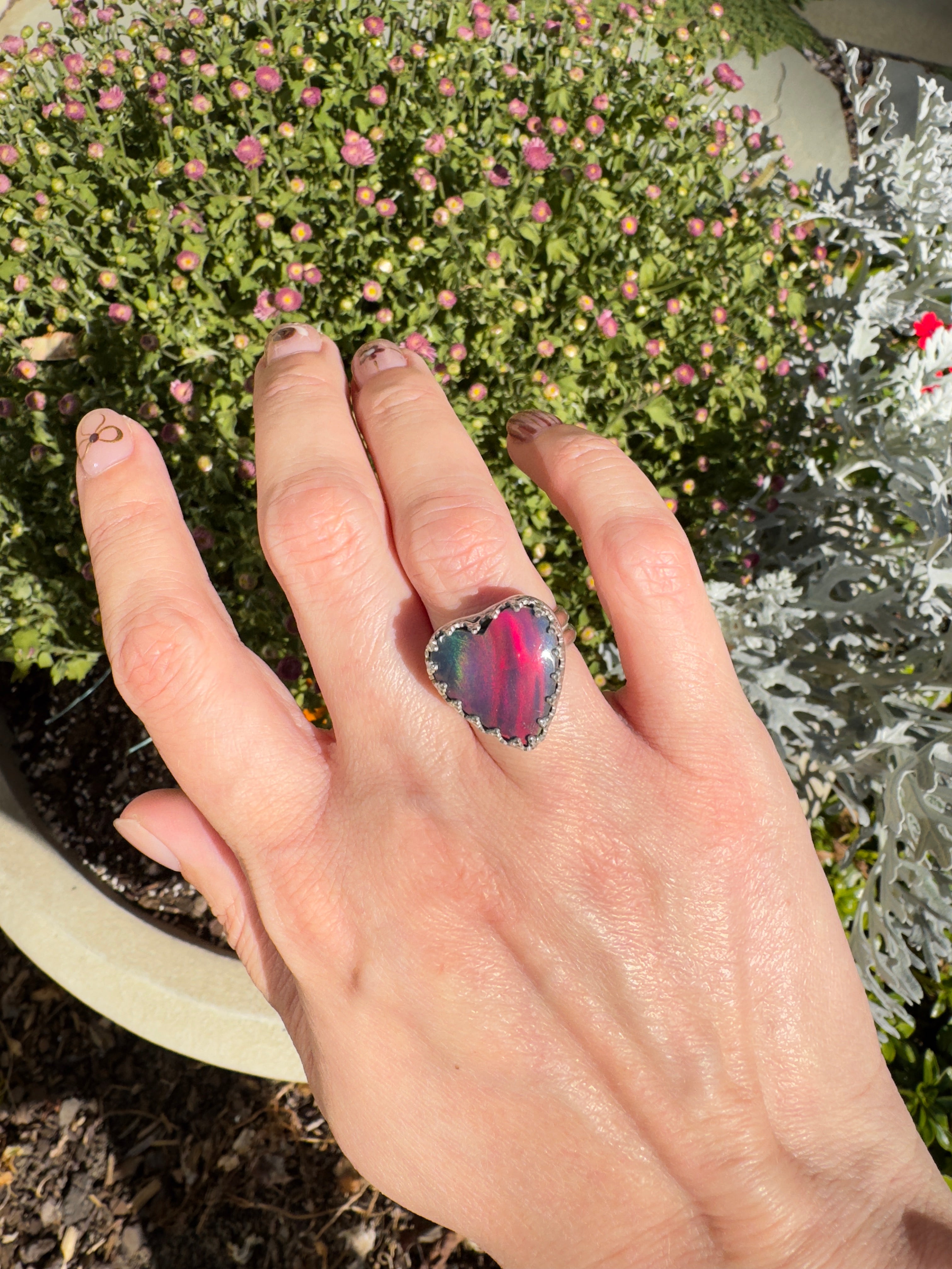 Beautiful heart shaped Aurora Opal on a wide sterling silver double band. So many pretty colors in this. One of a kind. The perfect heart ring for Valentine's Day. Size 6. Purple, blue, pink, and even green in this ring.