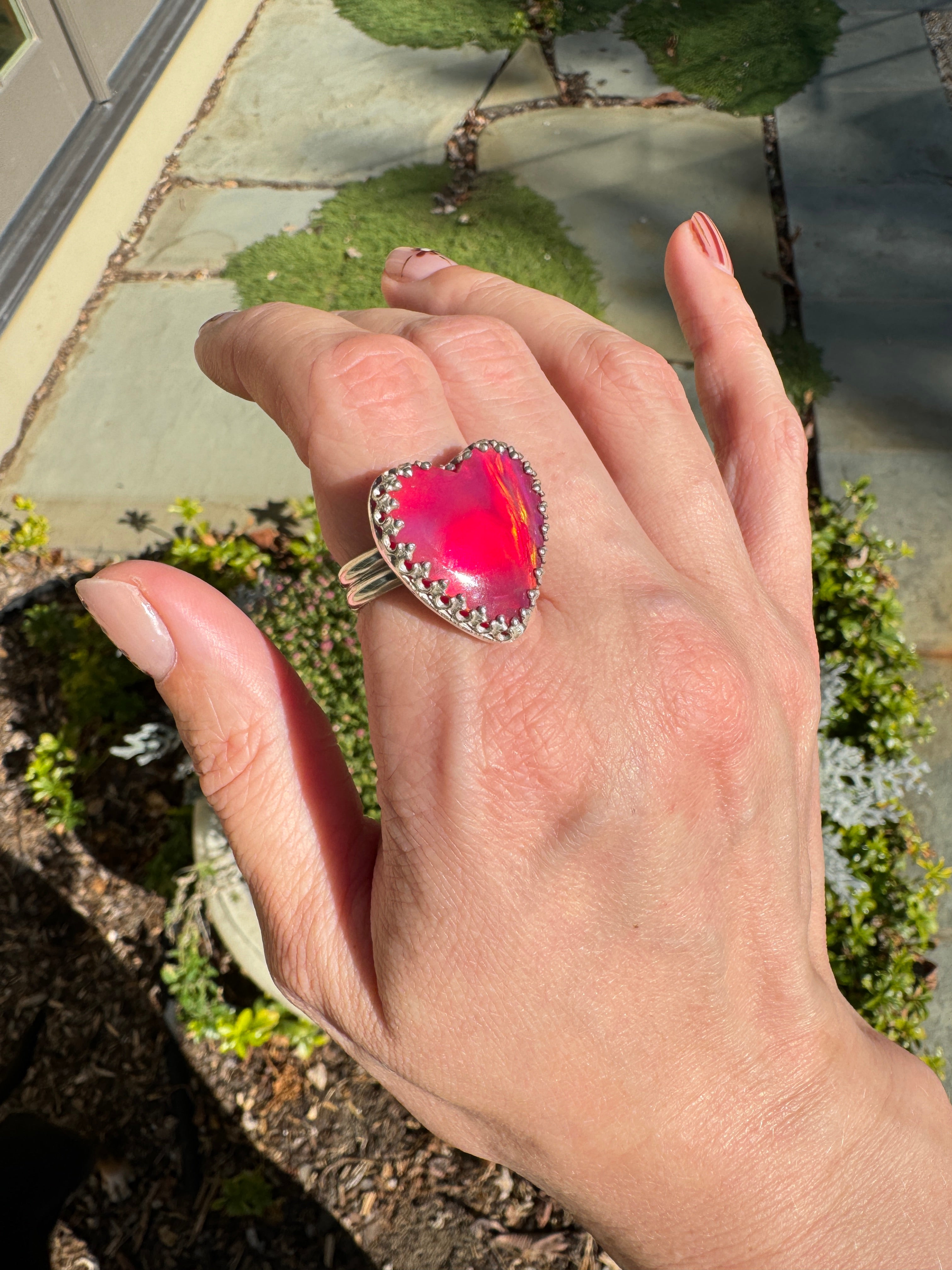 Beautiful heart shaped Aurora Opal on a wide sterling silver double band. Pretty tones of pink and red.  One of a kind. The perfect heart ring for Valentine's Day. Size 8