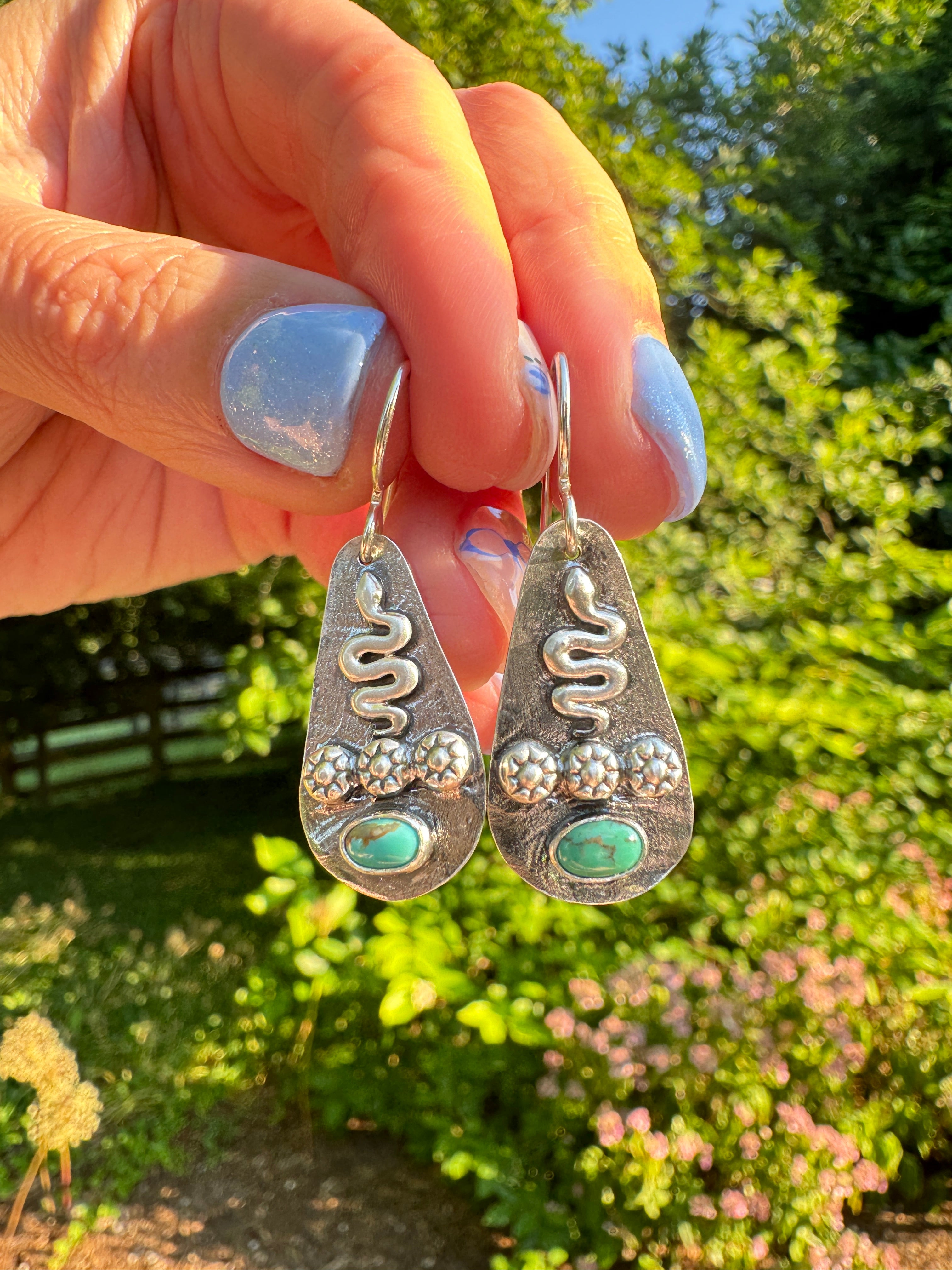 Sterling silver earrings with sterling silver snakes and carico lake turquoise. The ear wire is sterling silver. This is a one of a kind pair.