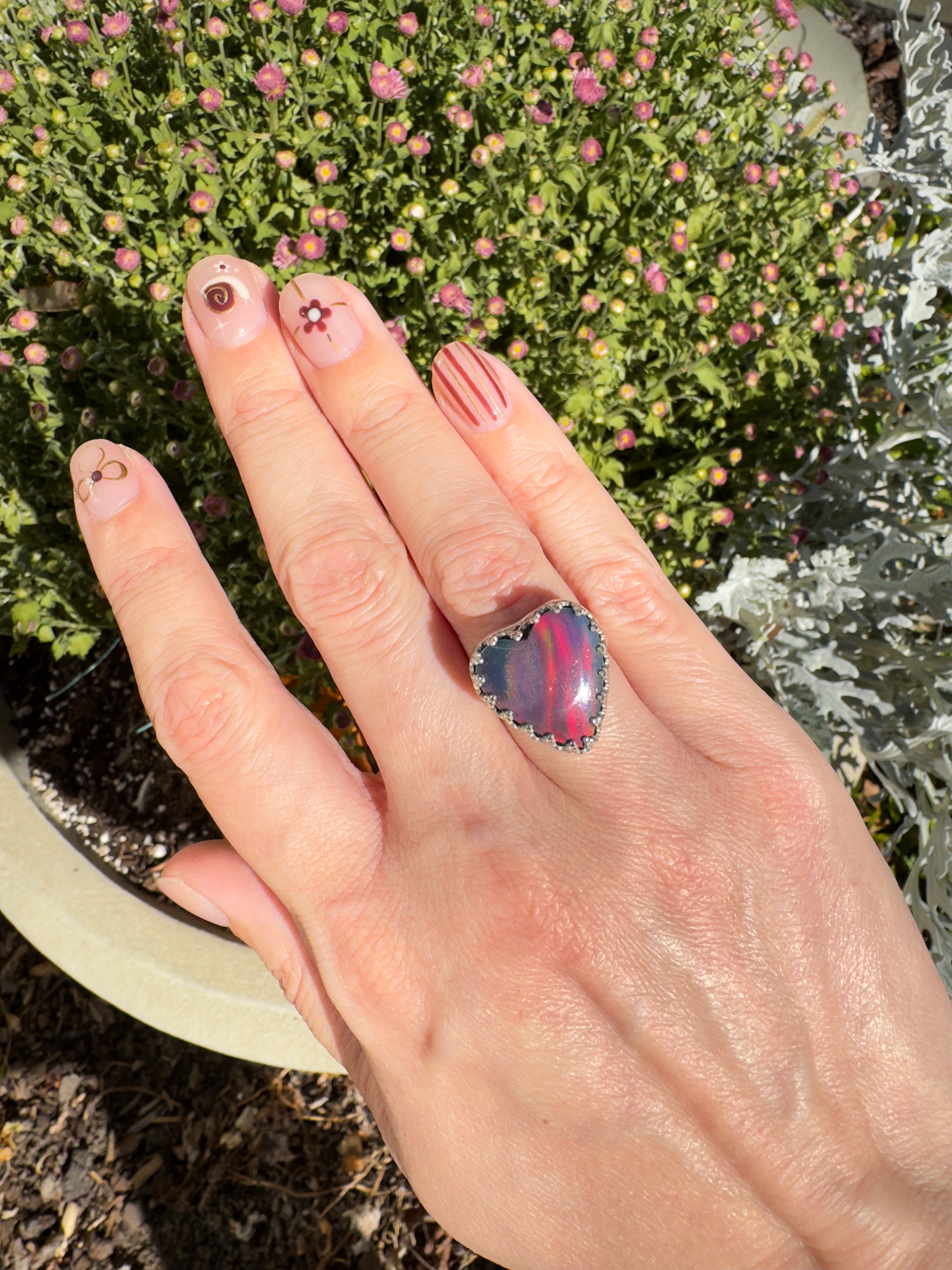 Beautiful heart shaped Aurora Opal on a wide sterling silver double band. So many pretty colors in this. One of a kind. The perfect heart ring for Valentine's Day. Size 6. Purple, blue, pink, and even green in this ring.