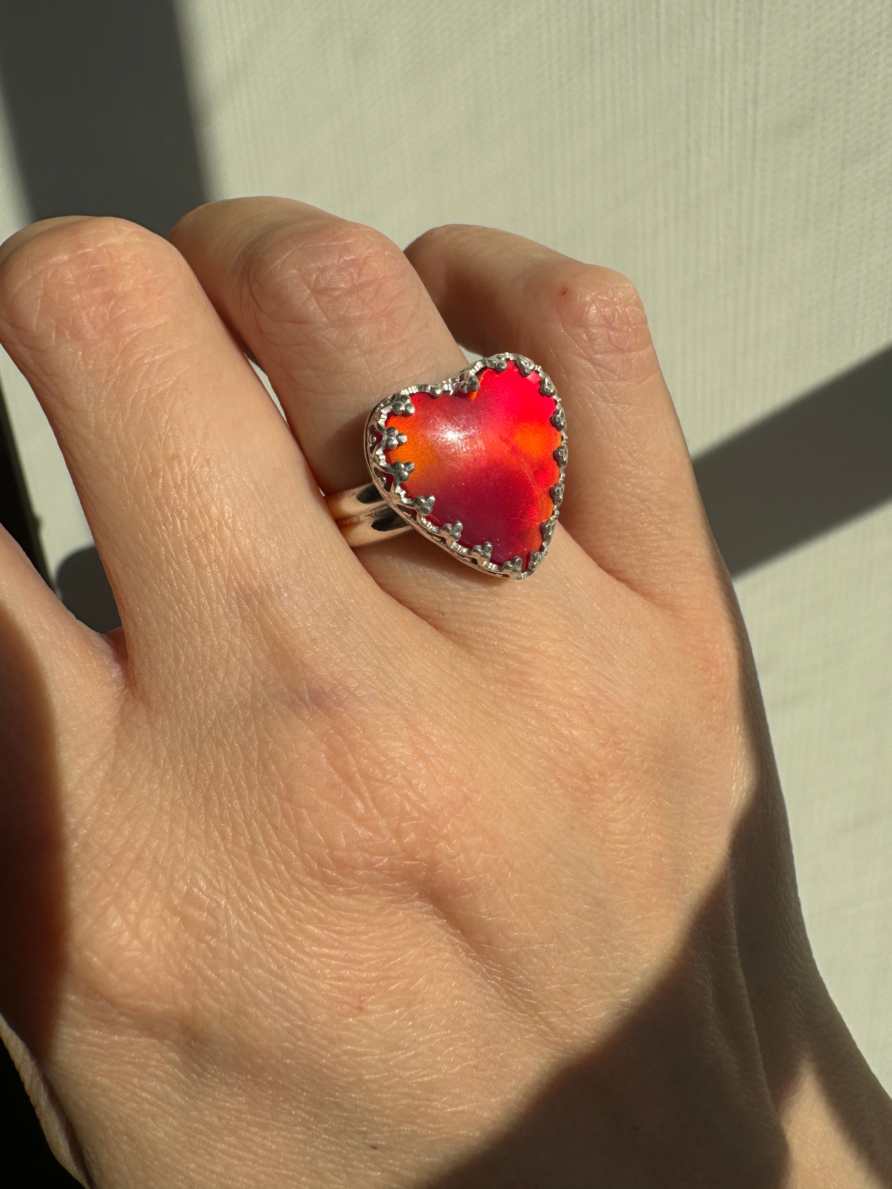 Beautiful heart shaped Aurora Opal on a wide sterling silver double band. Gorgeous bright pinks and reds in this stone. One of a kind. The perfect heart ring for Valentine's Day. Size 6.25