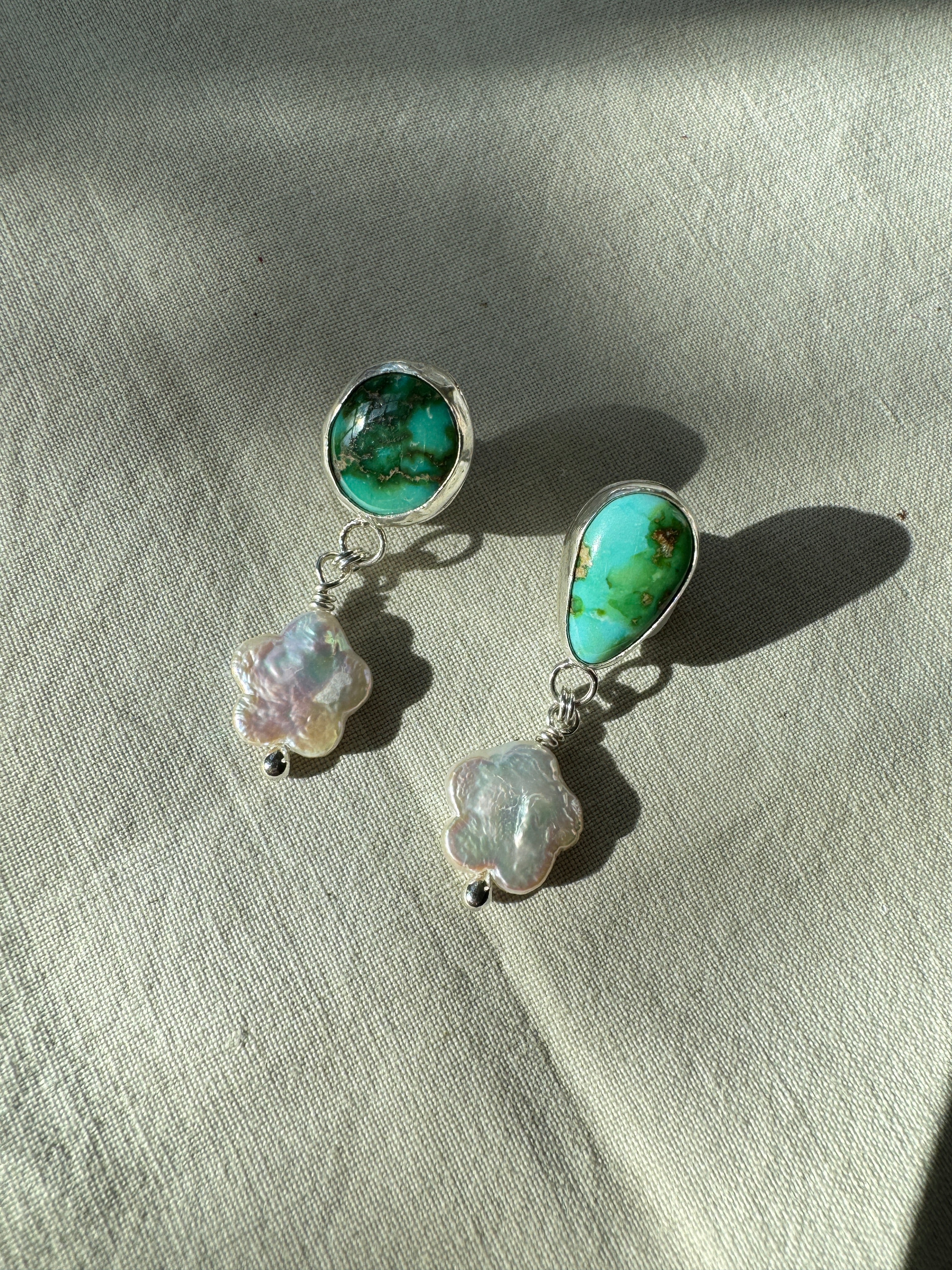 Verde Valley Turquoise set in a fine silver bezel with flower shaped pearls dangling below. The posts and ear backs are sterling silver.