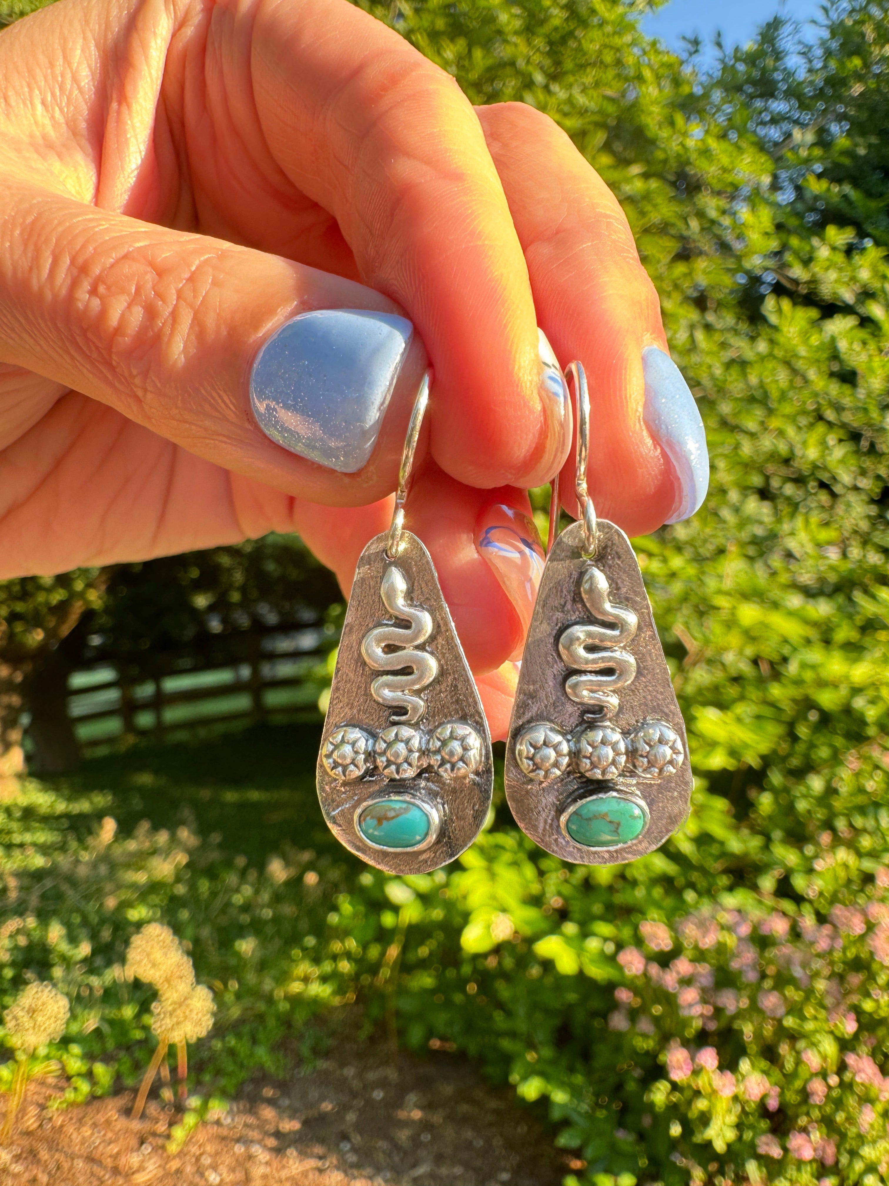 Sterling silver earrings with sterling silver snakes and carico lake turquoise. The ear wire is sterling silver. This is a one of a kind pair.