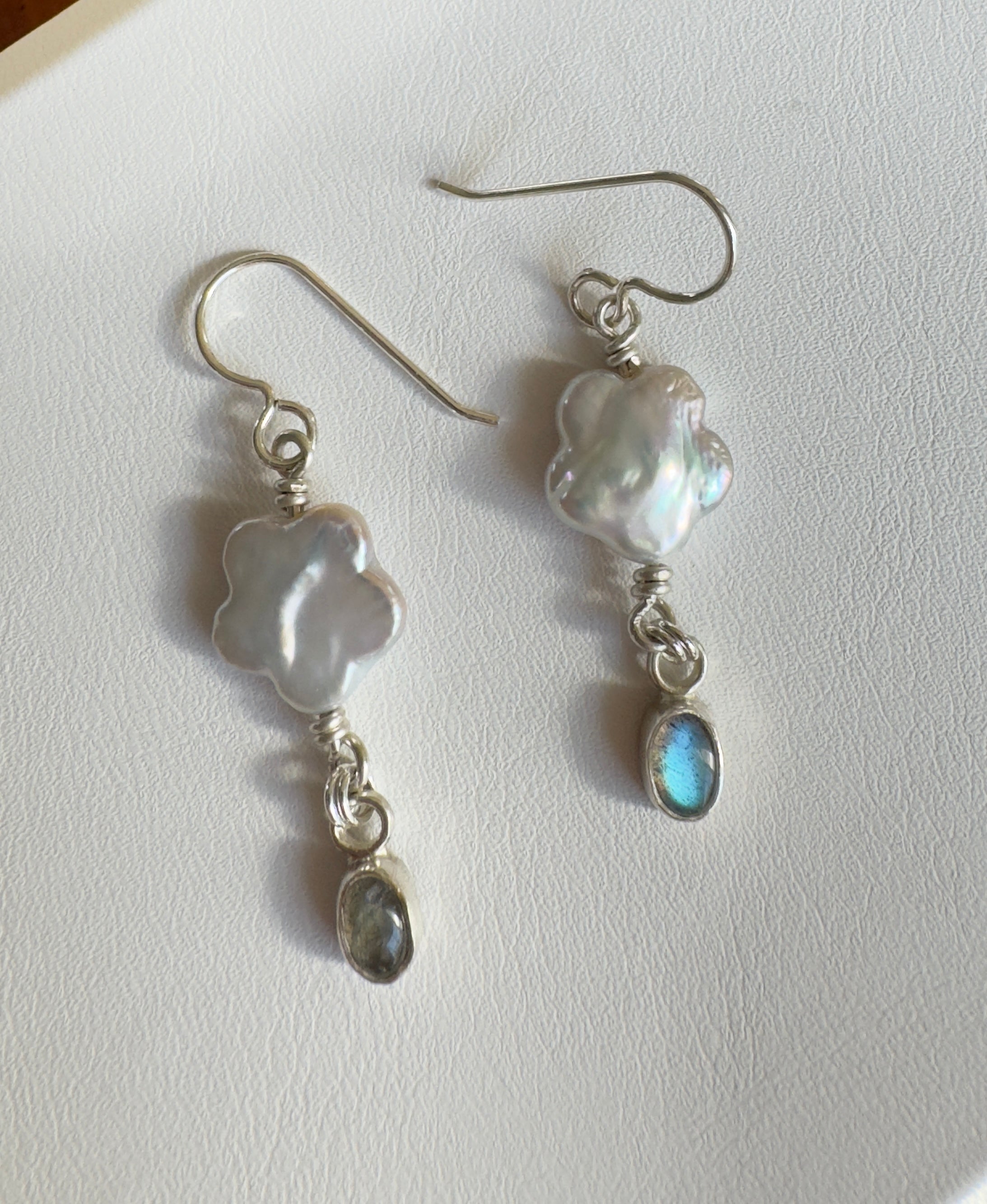 Freshwater flower shaped pearls with 4x6mm icy blue labradorite set in a fine silver bezel on a sterling silver back. 