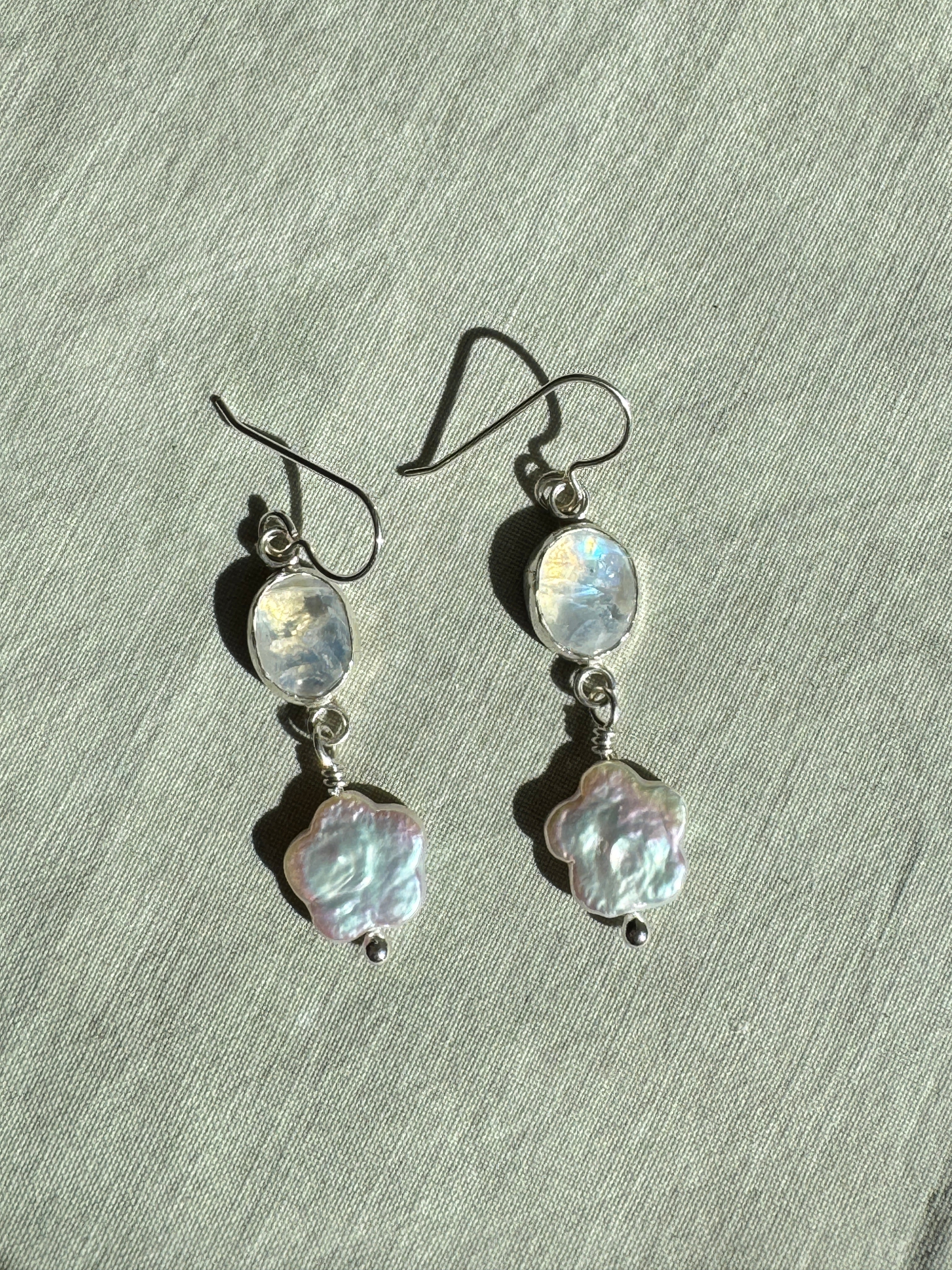 Sparkly moonstone set in a fine silver bezel on a sterling silver back with freshwater flower-shaped pearls dangling below.