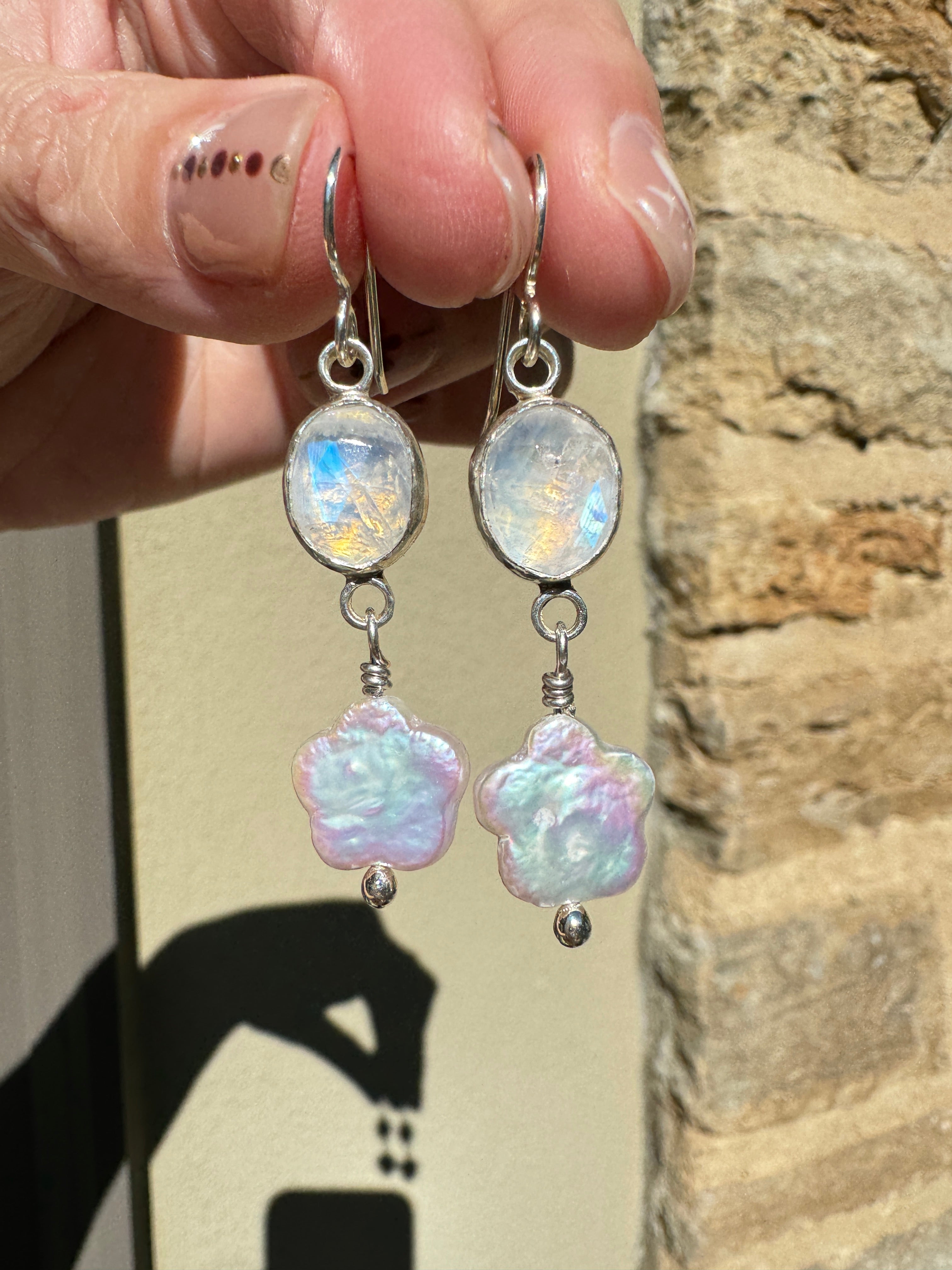 Sparkly moonstone set in a fine silver bezel on a sterling silver back with freshwater flower-shaped pearls dangling below.