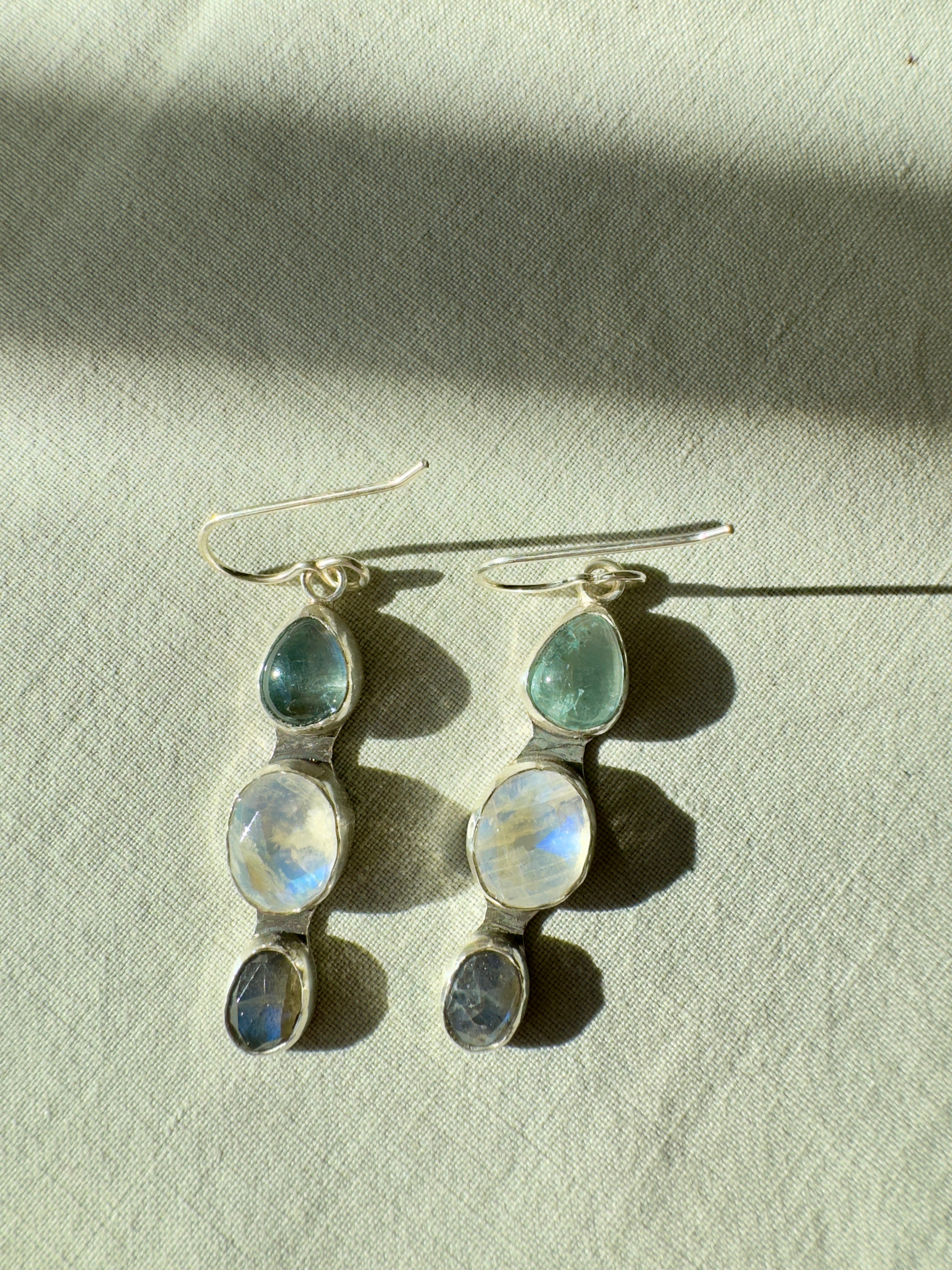 Icy blues of aquamarine, moonstone and labradorite set in fine silver bezels on a sterling silver back. 