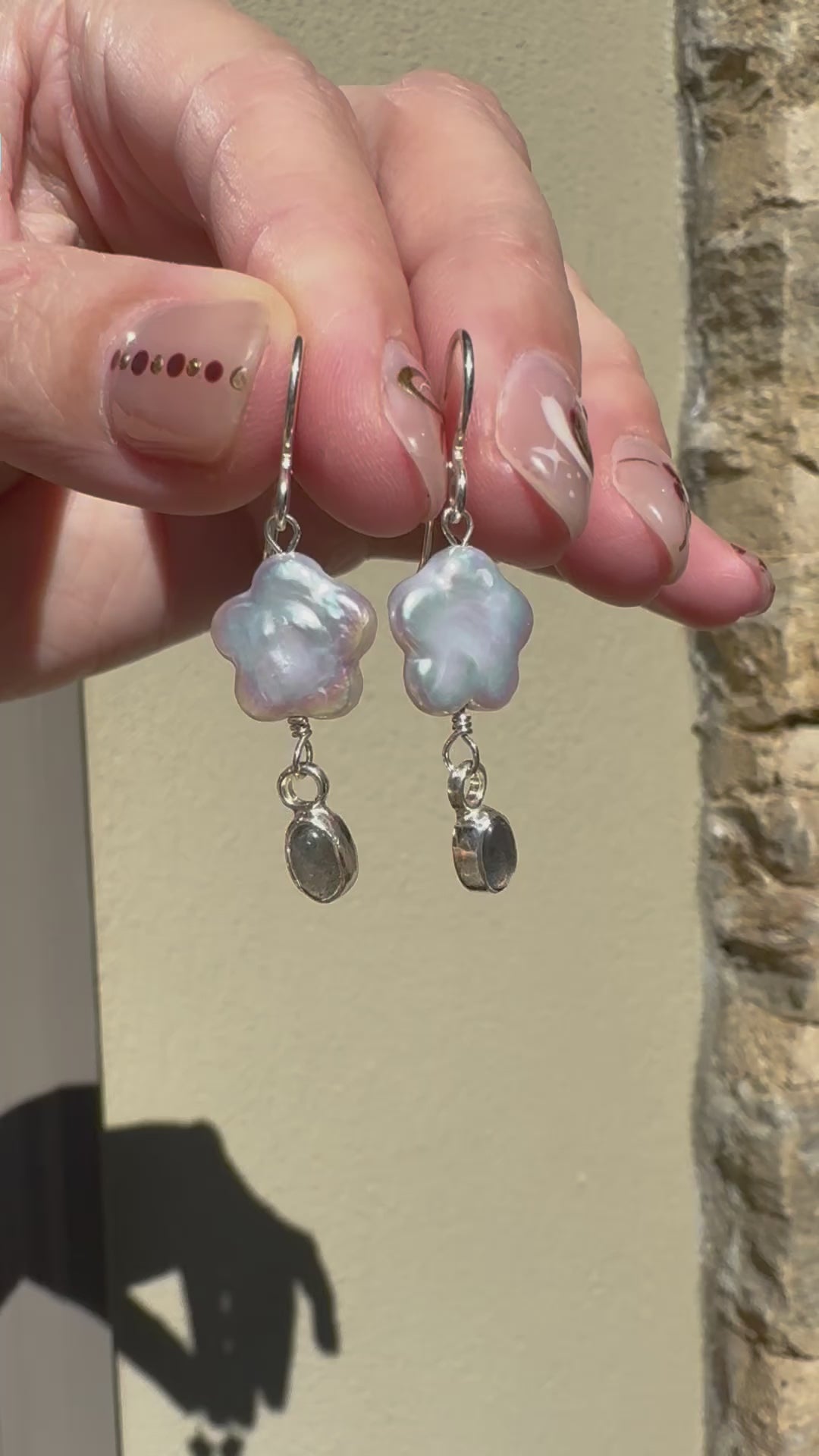 Freshwater flower shaped pearls with 4x6mm icy blue labradorite set in a fine silver bezel on a sterling silver back. 